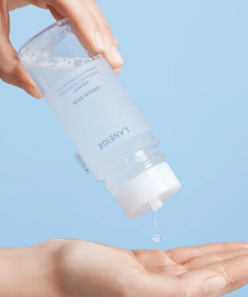 Pouring LANEIGE NEW Gel Cream Skin 170ml into hand with blue background.