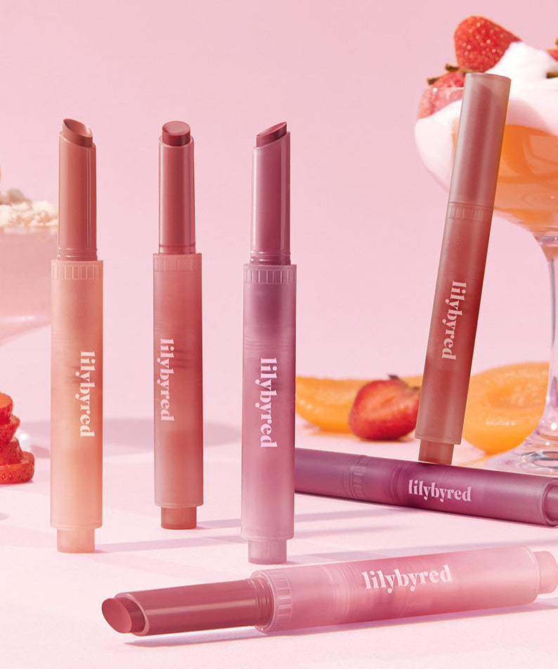 LILYBYRED Milky Blur Fondue Bar makeup collection with lipstick shades set against a strawberry and dessert backdrop.