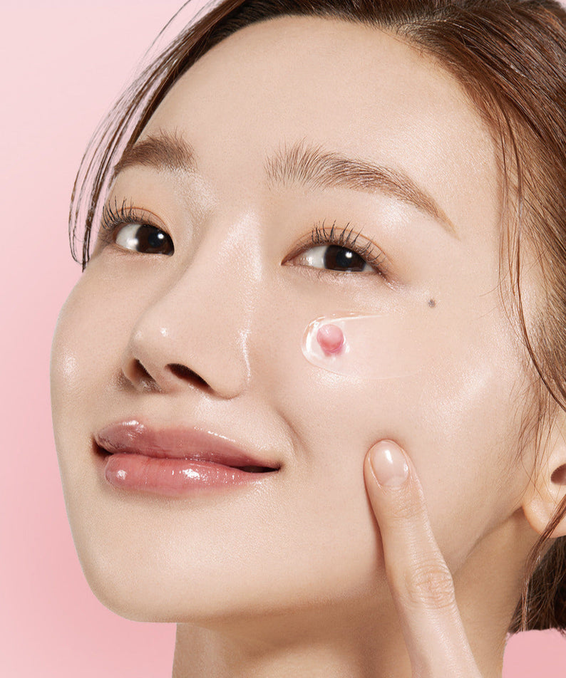 Woman applying MEDICUBE PDRN Pink Collagen Capsule Cream 55g on her face