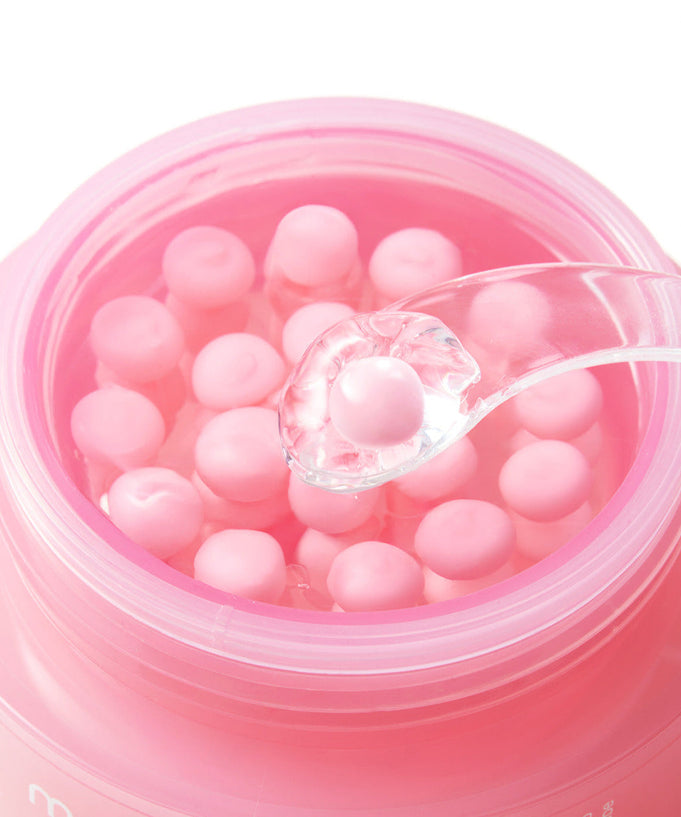 Open jar of MEDICUBE PDRN Pink Collagen Capsule Cream 55g with visible pink capsules and a clear spoon.