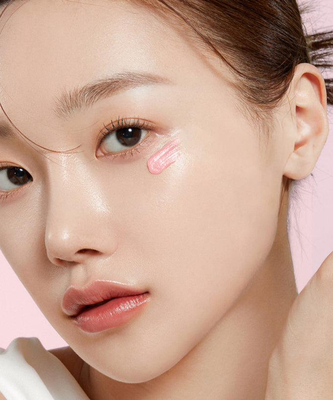 Model applying MEDICUBE PDRN Pink Peptide Eye Cream 30ml on face for skincare