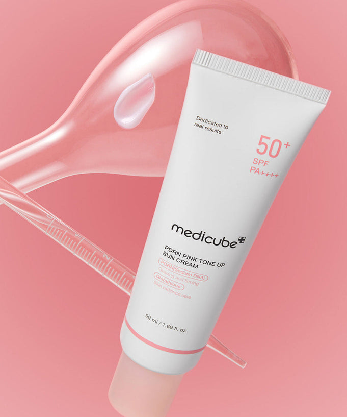 MEDICUBE PDRN Pink Tone-Up Sun Cream 50ml with SPF 50+ for radiant skin protection displayed on a pink background