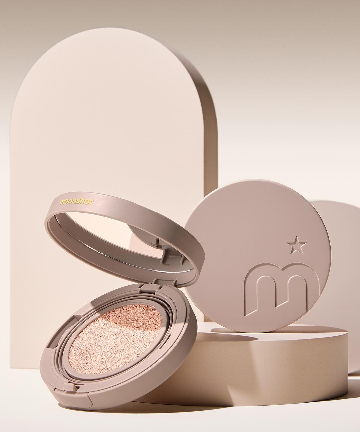 MOONSHOT Conscious Fit Cushion Foundation in open compact case with beige background