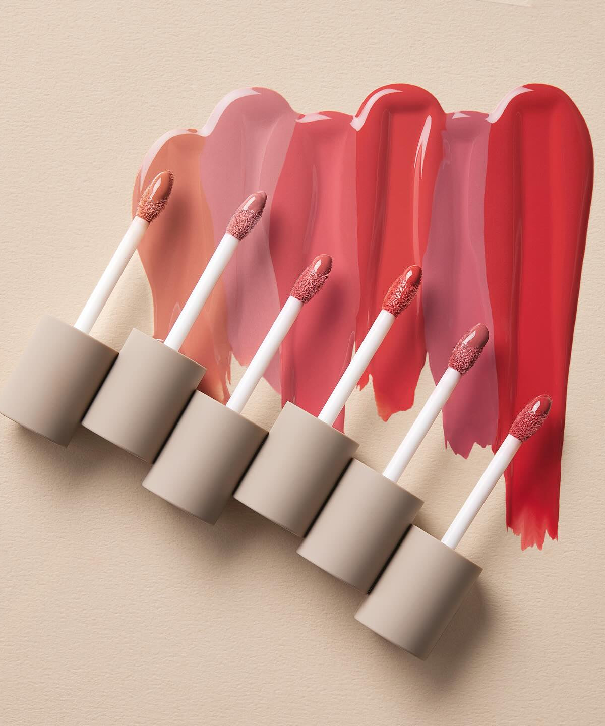 MOONSHOT Conscious Fit Melow Lip Tint in various shades with applicator wands on a neutral background