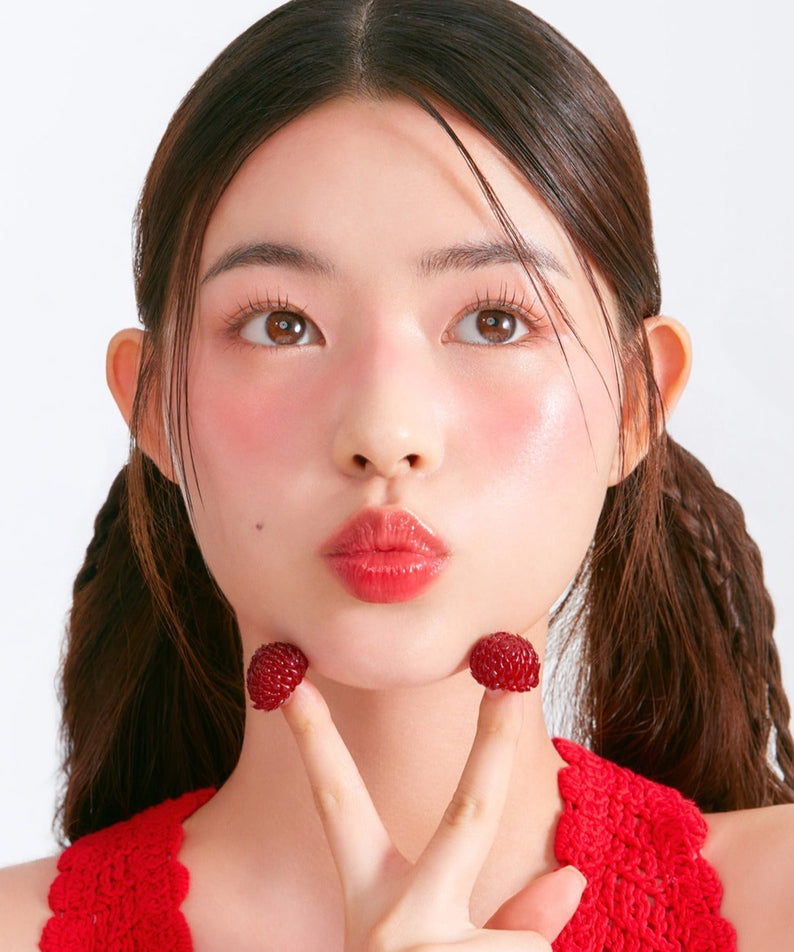 Woman wearing MOONSHOT Melting Mood Lip & Cheek with berry accents and red top