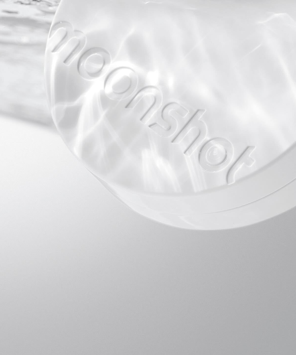 MOONSHOT Conscious Fit Glow Cushion Foundation compact with water reflection