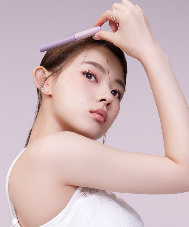 Woman applying MUDE Inspire Skinny Brow Cara for defined eyebrows