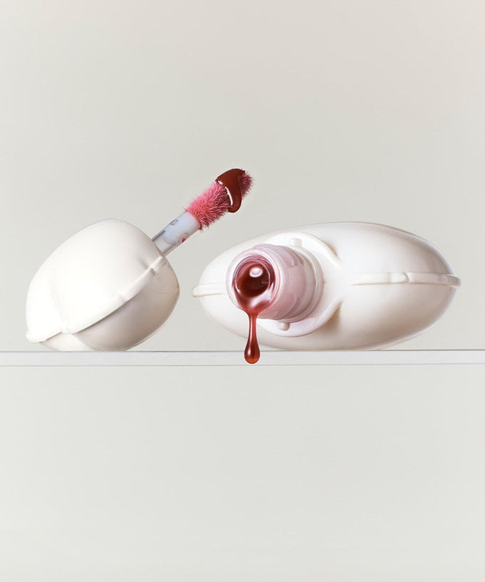 NAMING Glow Heart Lip Tint product with open applicator and drop of color.