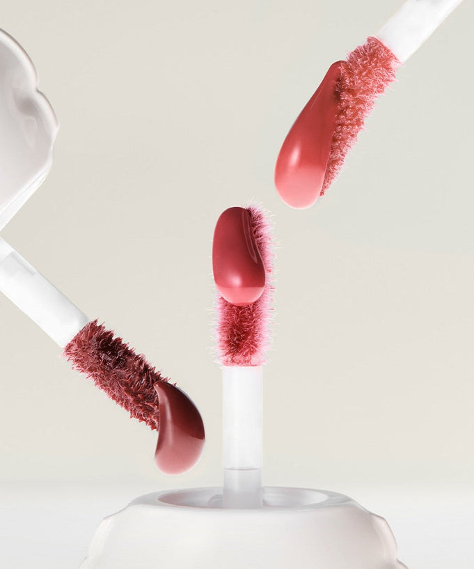 NAMING Glow Heart Lip Tint applicators with vibrant color swatches on a neutral background.