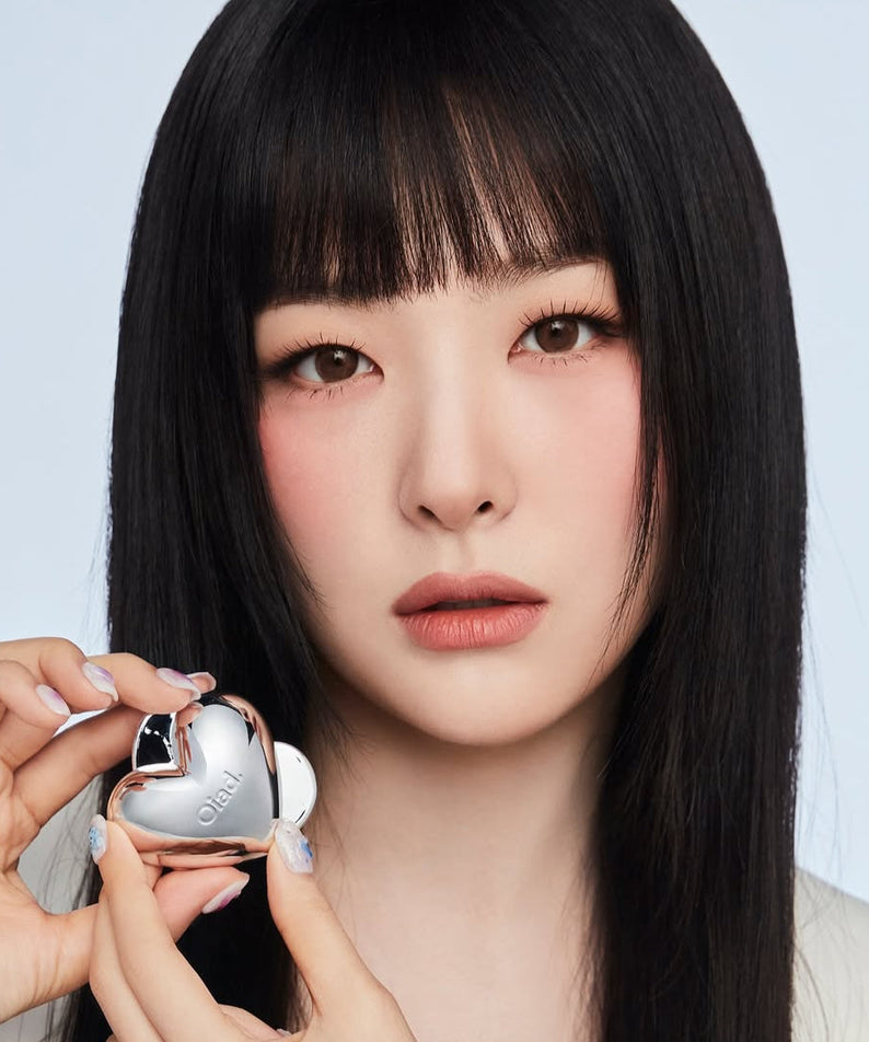 Model holding OIAD Silverpulse Moussecream Lip&Cheek product, showcasing dual-use lip and cheek makeup in heart-shaped packaging.