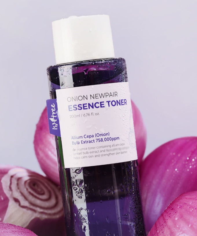 ISNTREE Onion Newpair Essence Toner 200ml with onion extract for skin care, 200ml bottle surrounded by sliced onions.