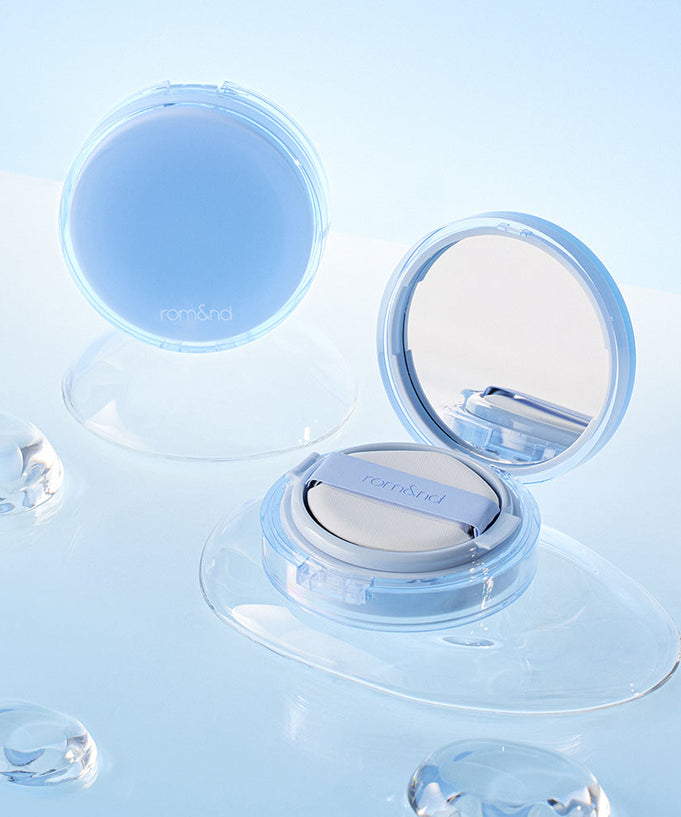 ROMAND bare water cushion displayed with open compact and water droplets on a light blue background