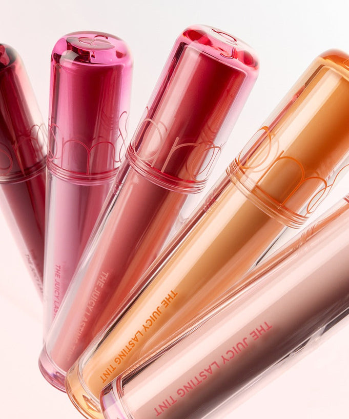 Assorted shades of ROMAND The Juicy Lasting Tint lip products displayed elegantly.