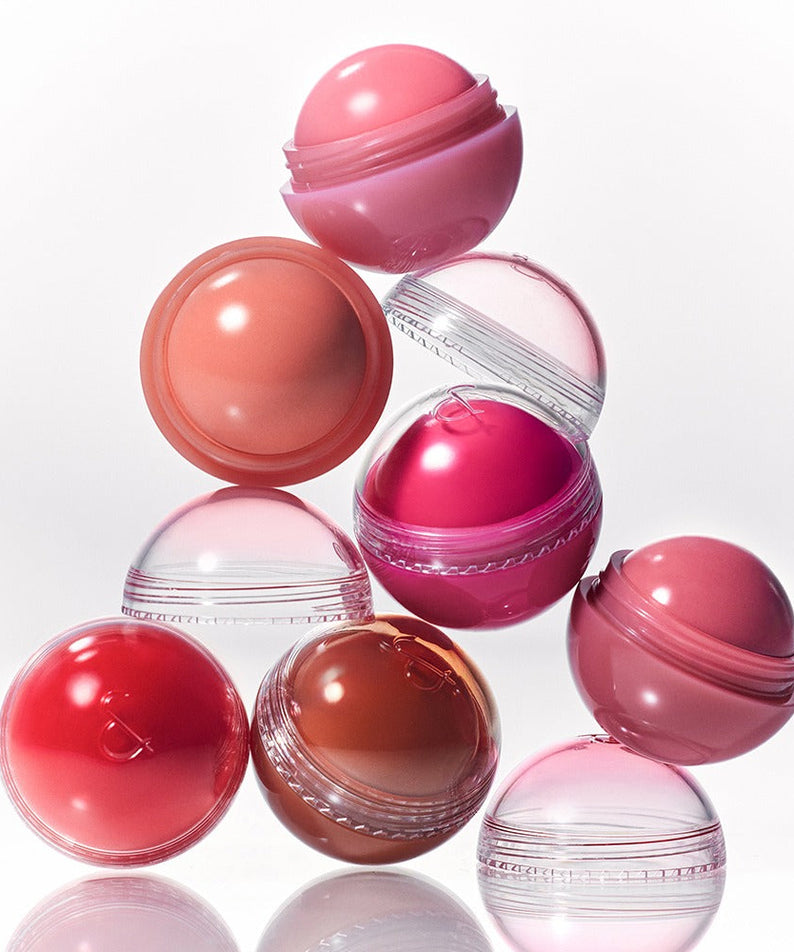 Colorful ROMAND Juicy roll cheek compacts stacked in a creative arrangement.