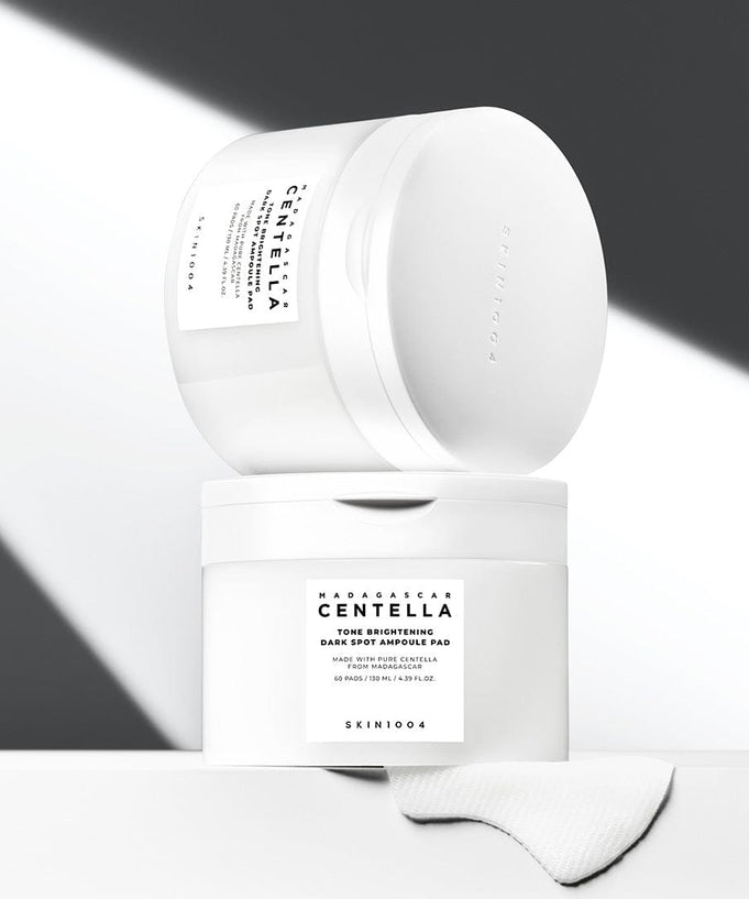 SKIN1004 Madagascar Centella Tone Brightening Dark Spot Ampoule Pads (60 sheets) in minimalist packaging displayed on a light background.