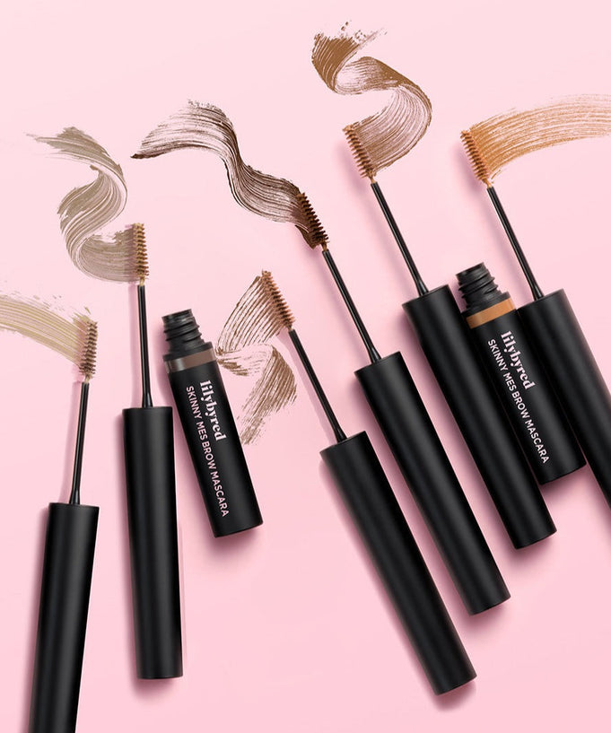 LILYBYRED Skinny Mes Brow Cara in multiple shades on a pink background