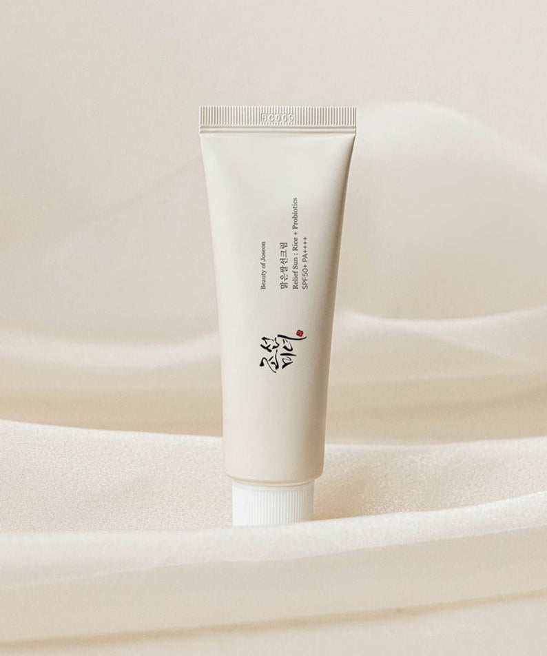 BEAUTY OF JOSEON Relief Sun Rice Sun Cream 50ml tube on a soft fabric background