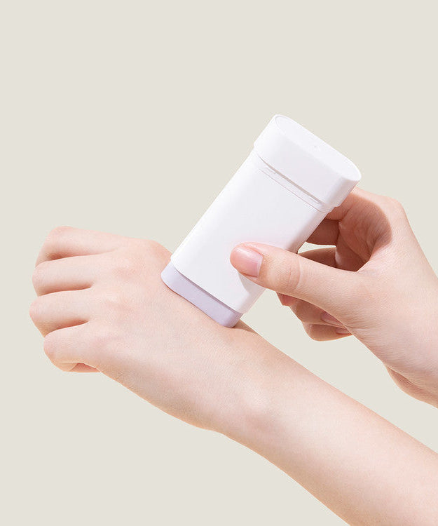 Hands applying MARY & MAY Vegan Peptide Bakuchiol Sun Stick on skin for sun protection