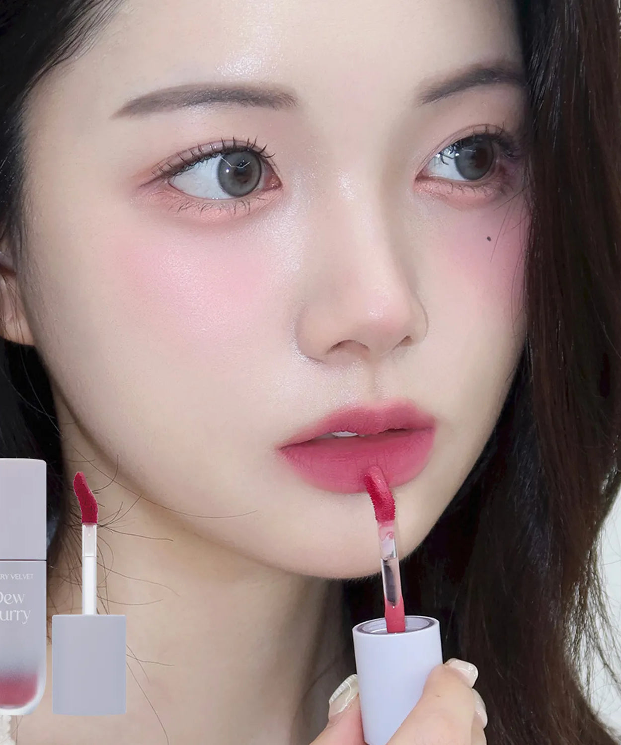 TOO COOL FOR SCHOOL Dew Blurry Tint applied on model's lips with product packaging in view.
