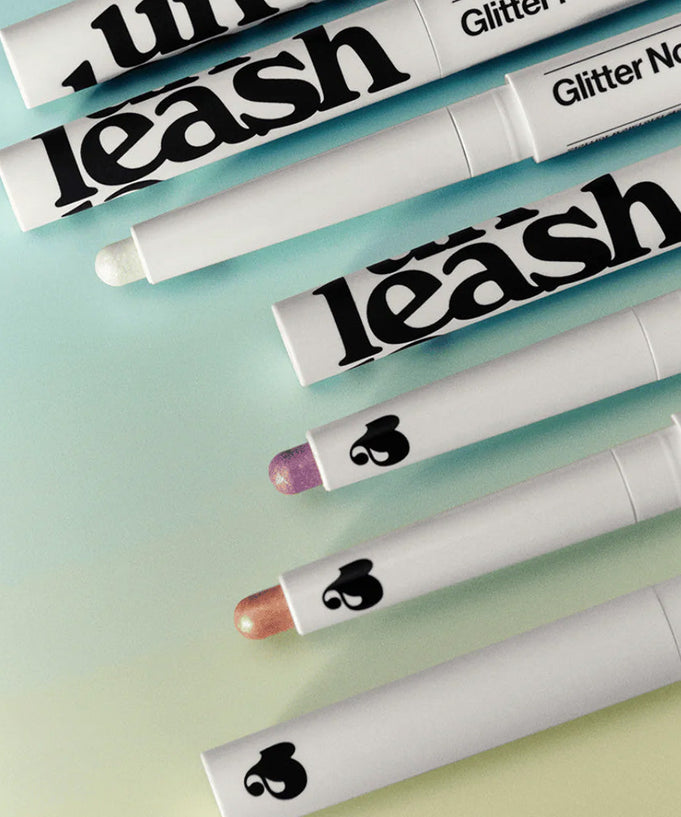 UNLEASHIA Pretty Easy Glitter Stick makeup collection in multiple colors on gradient background