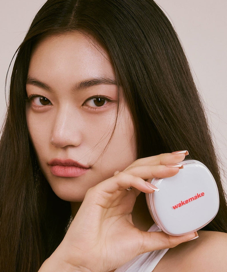 Woman holding WAKE MAKE Seamless Wear Cushion 15g