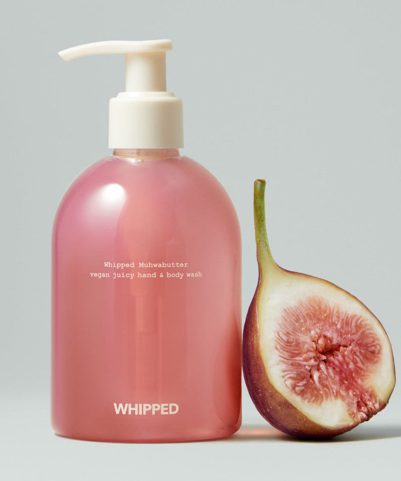 WHIPPED Muhwabutter Vegan Juicy Hand & Body Wash 290ml bottle with a fig beside it.